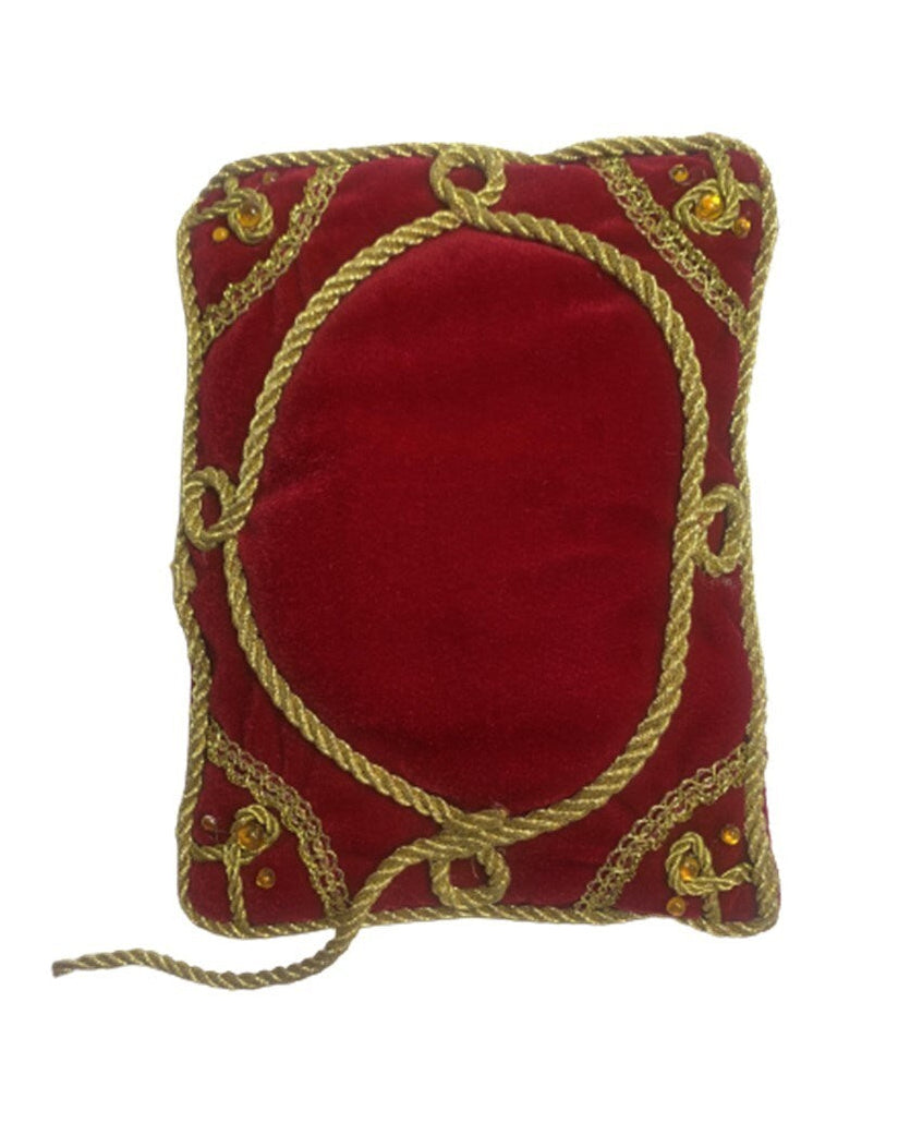 Red pillow with gold embroidery on a white background