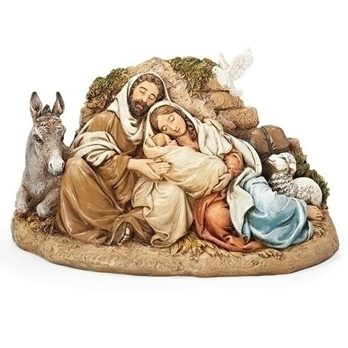 A statue depicting the Holy Family with Joseph, Mary, and baby Jesus, accompanied by a donkey, seated on a rock-like surface.