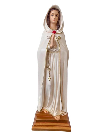 Statue of a religious figure in a white robe with a red flower on a white background