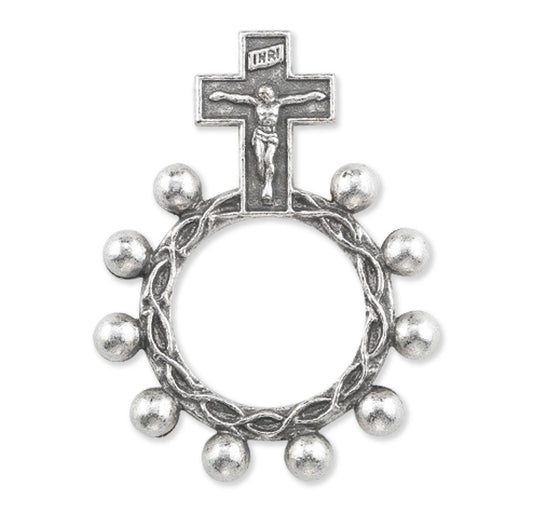 Silver cross with a wreath of small silver balls on a white background