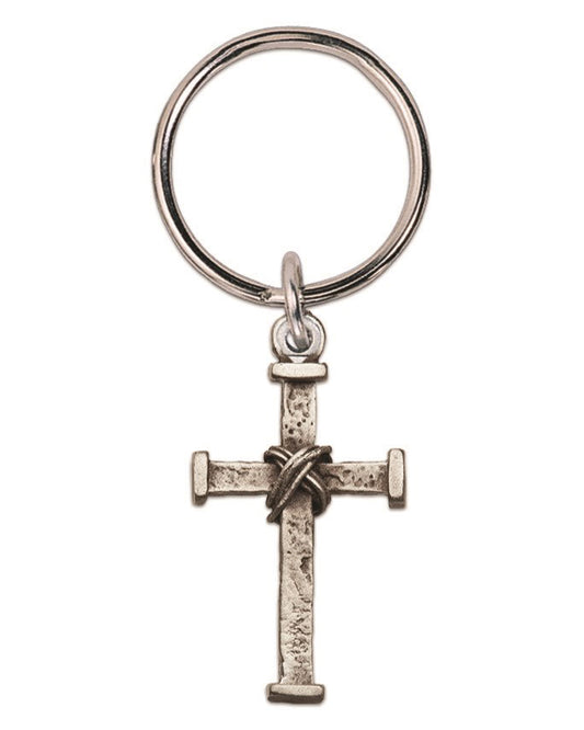 A silver-toned metal keychain featuring a textured cross charm with a knotted rope detail at the center, attached to a split key ring, shown against a plain white background.