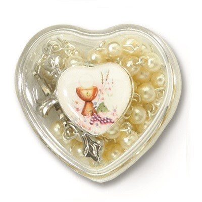 Heart-shaped container with a small figurine and pearls on a white background