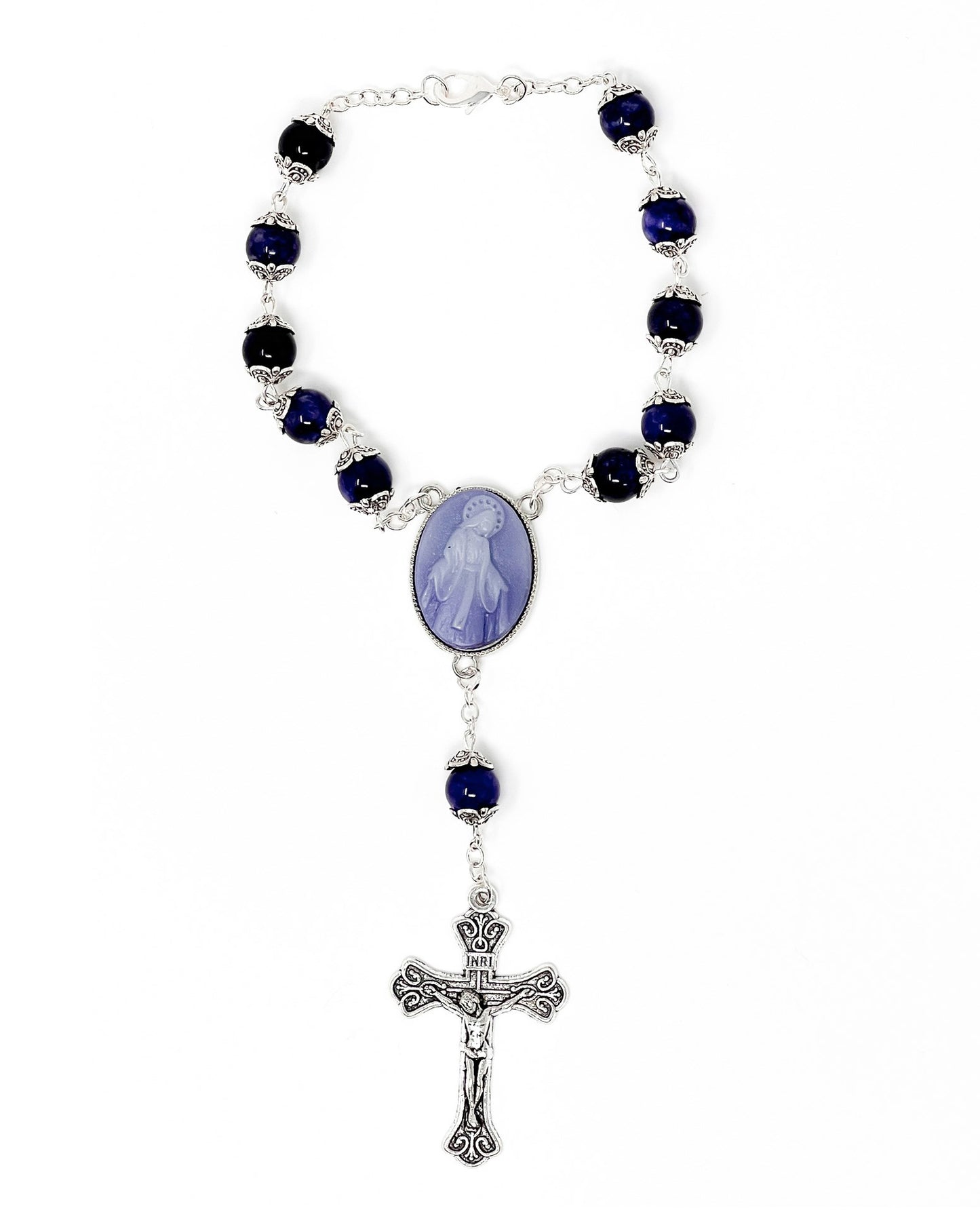 Rosary with blue beads and a central oval pendant on a white background