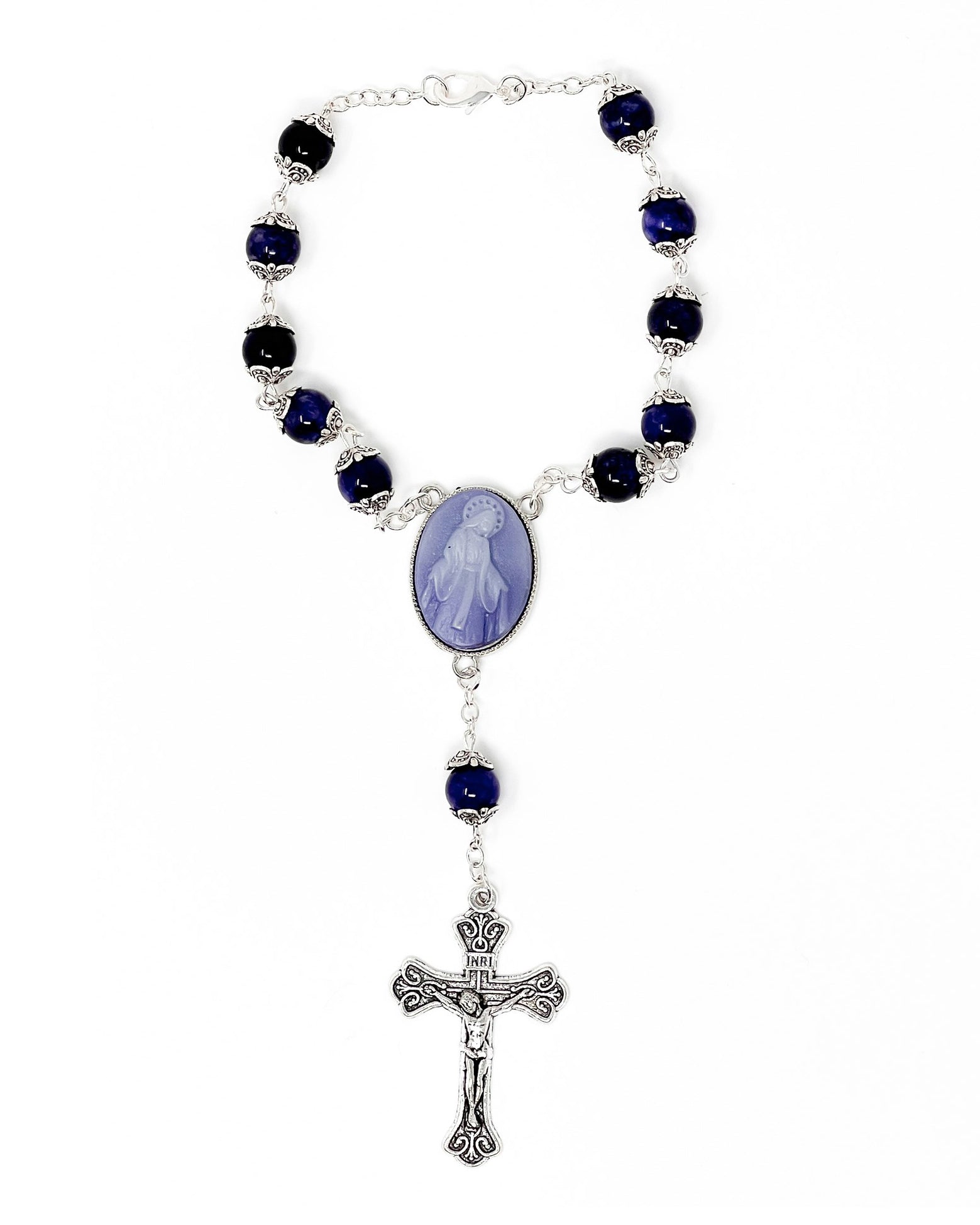 Rosary with blue beads and a central oval pendant on a white background