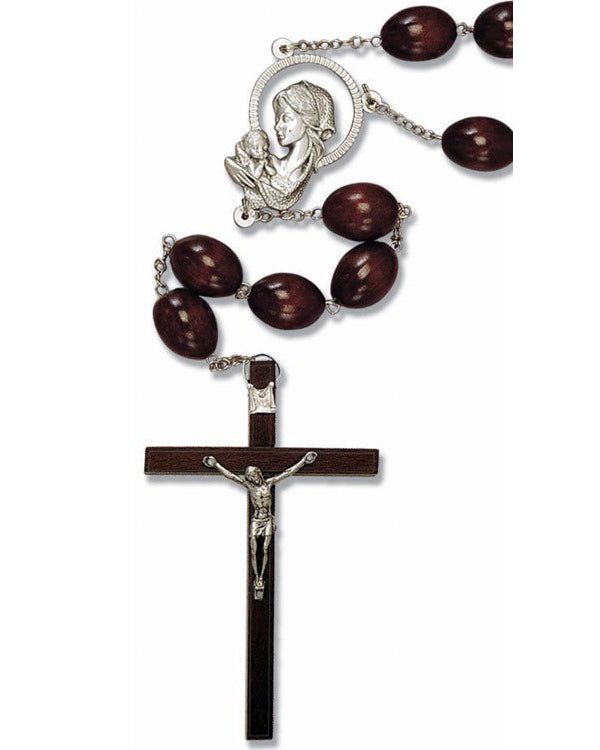 Wooden wall rosary with silver crucifix and medal on a white background