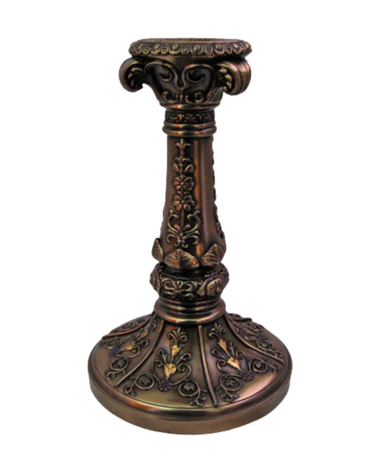 Decorative bronze candle holder with intricate designs on a white background