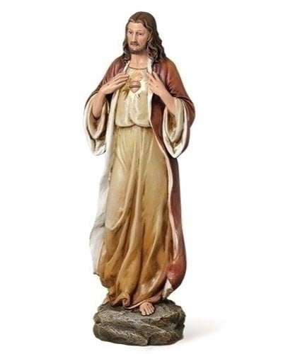 Statue of a religious figure with draped robes on a white background