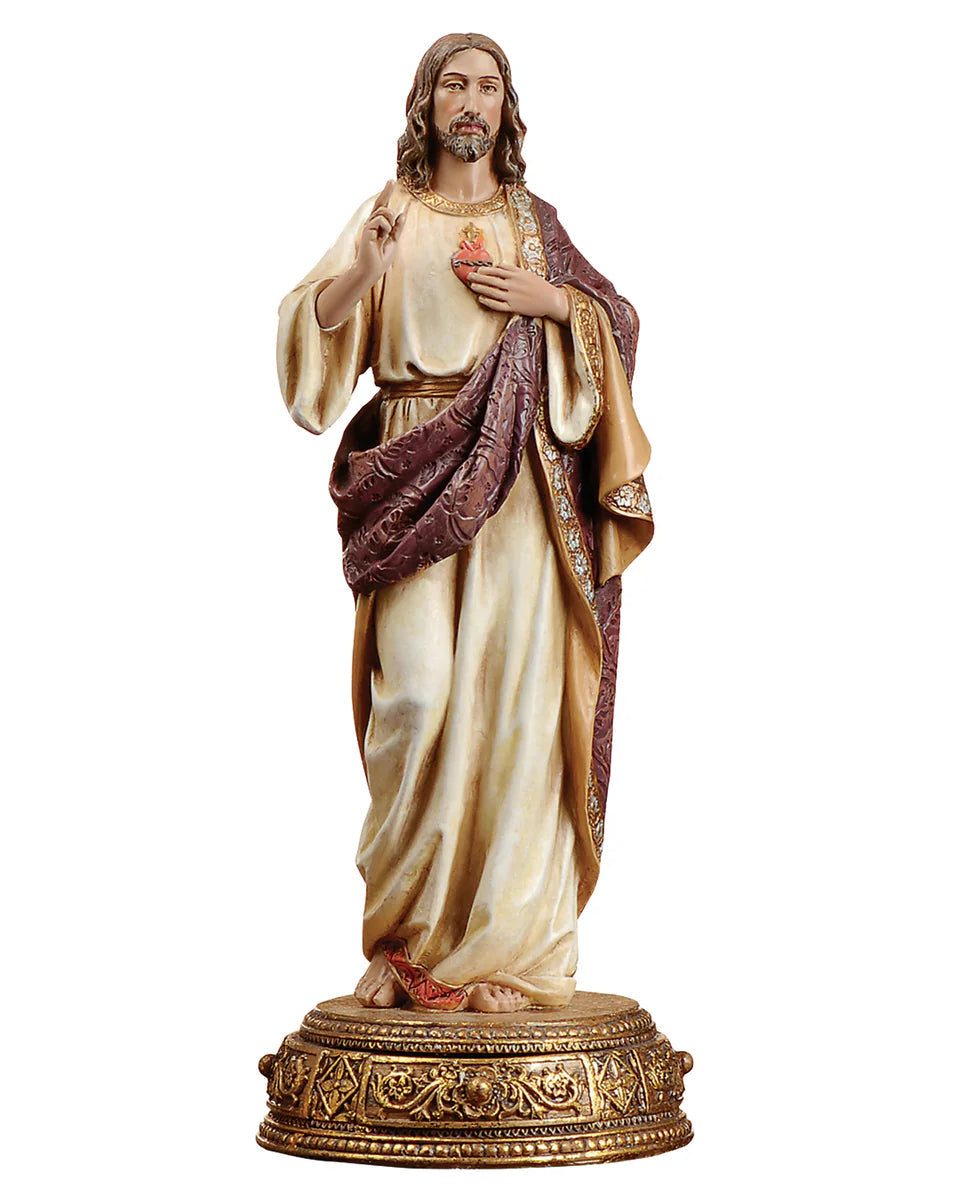 Statue of a religious figure in ornate robes on a white background