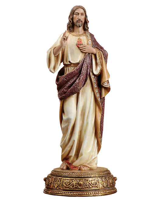 Statue of a religious figure in ornate robes on a white background