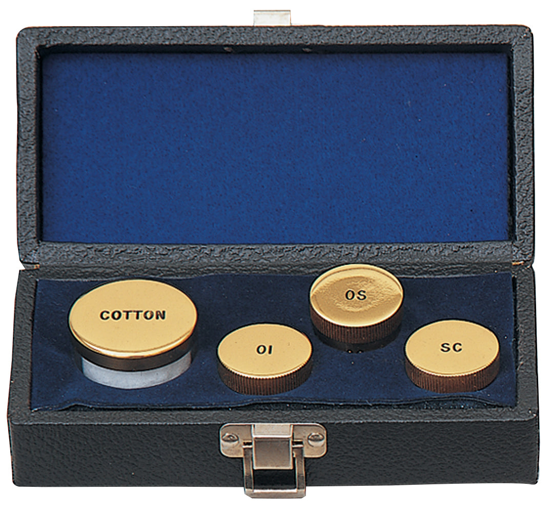 Set of brass buttons with labels in a black case on a white background