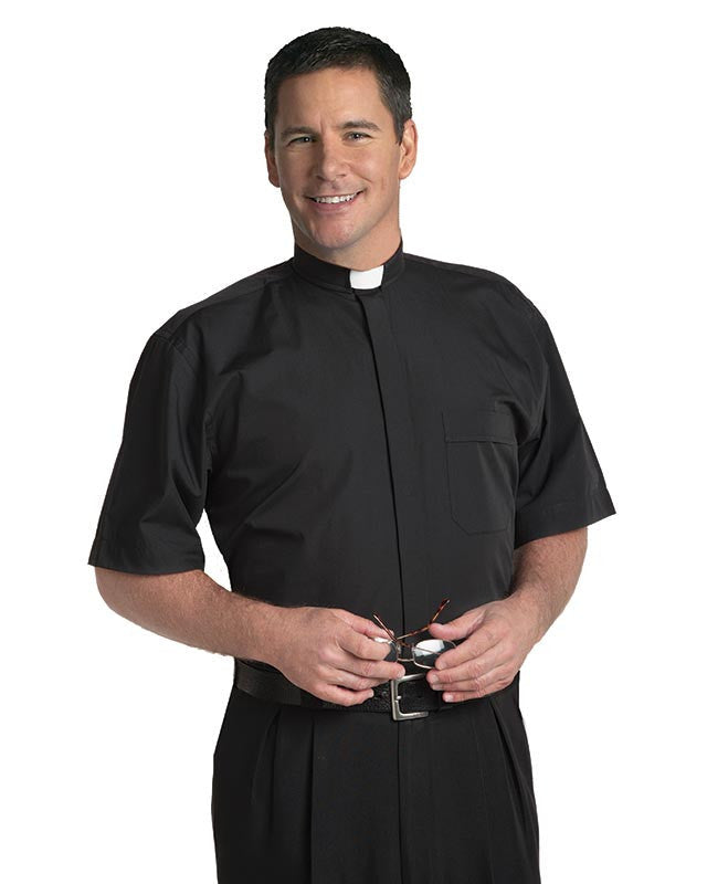 Man wearing a black clerical shirt with a white collar on a white background
