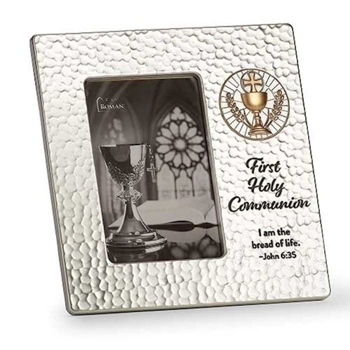 A silver-toned, resin picture frame with a textured finish and gold tone accents, featuring a First Holy Communion theme, holding a picture of a chalice and Host.