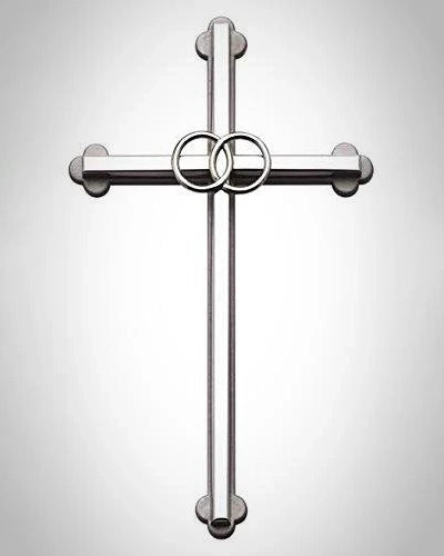 Metallic cross with circular design on a light gray background