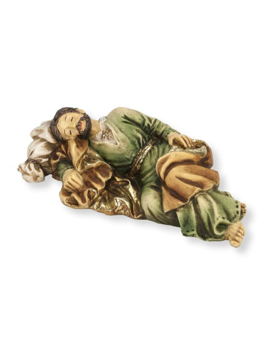 Decorative figurine of a person in green and gold attire on a white background