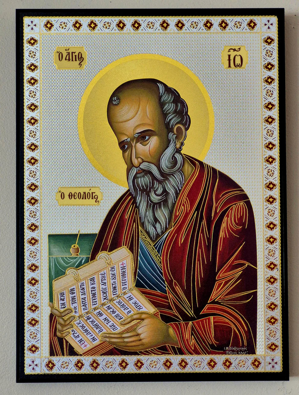 Decorative icon of a religious figure with ornate border on a plain background