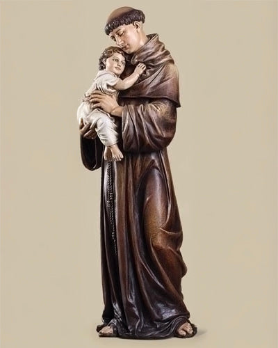 Statue of a religious figure holding a child against a beige background
