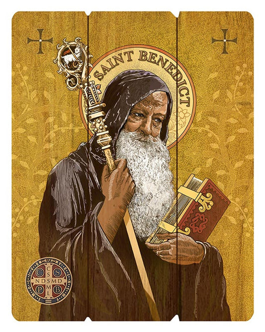A wooden pallet sign featuring an illustration of St. Benedict in monastic robes holding a book and a staff, with a yellow background and decorative elements.