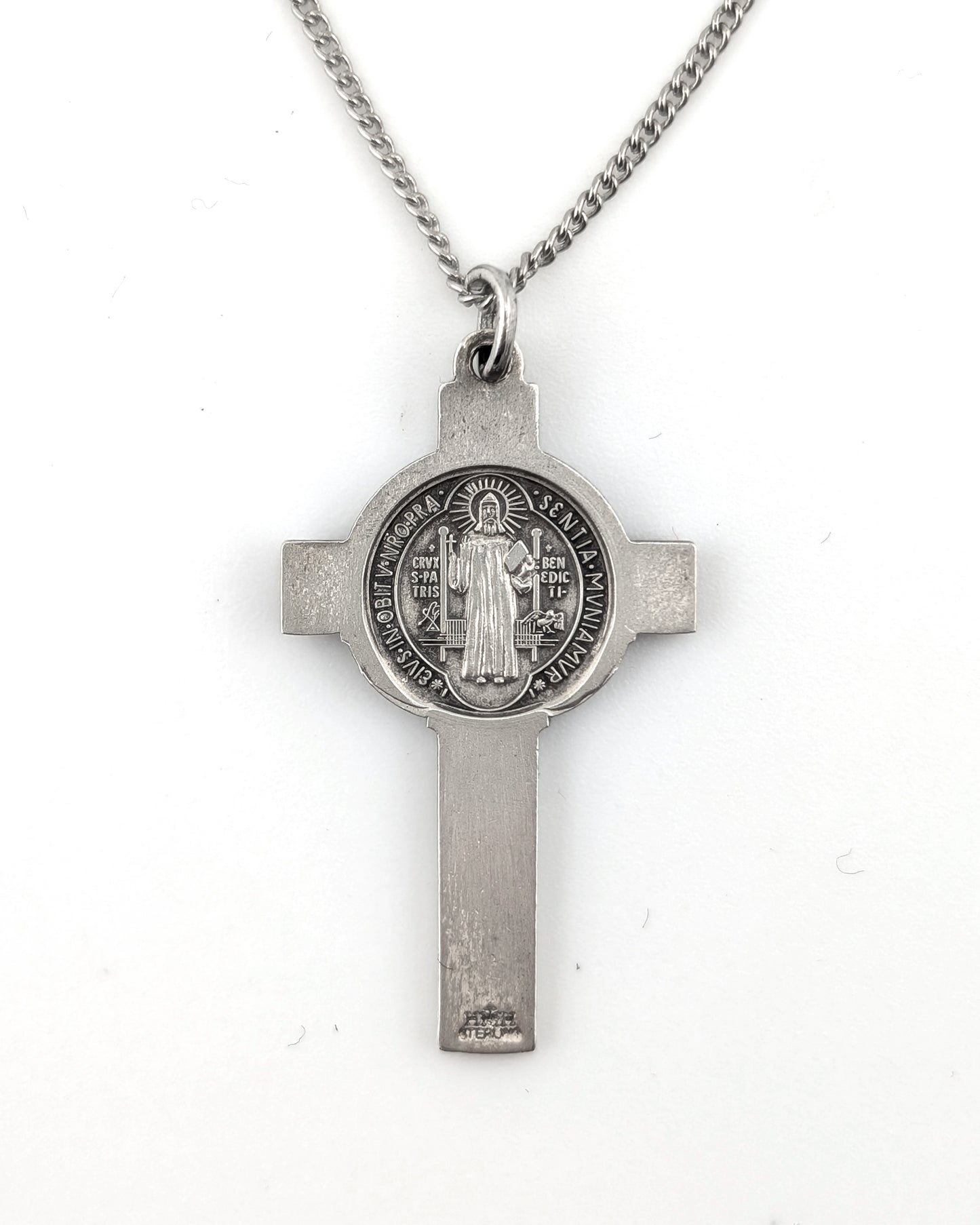 Silver cross pendant necklace on a white background