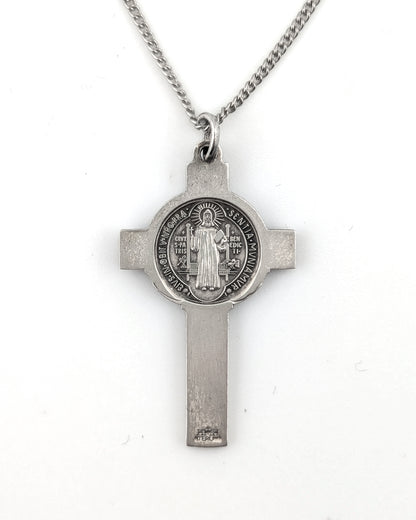 Silver cross pendant necklace on a white background