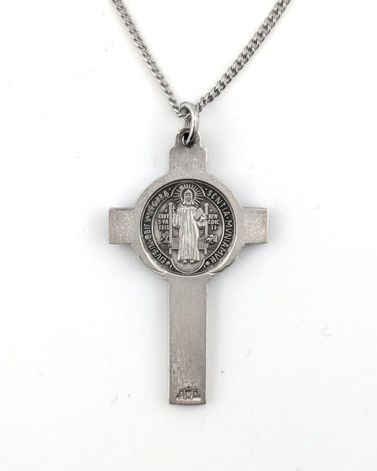 Silver cross pendant necklace on a white background