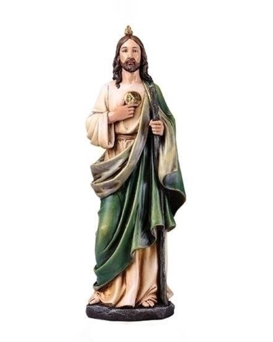 Statue of a religious figure with green robe and white garment on a white background