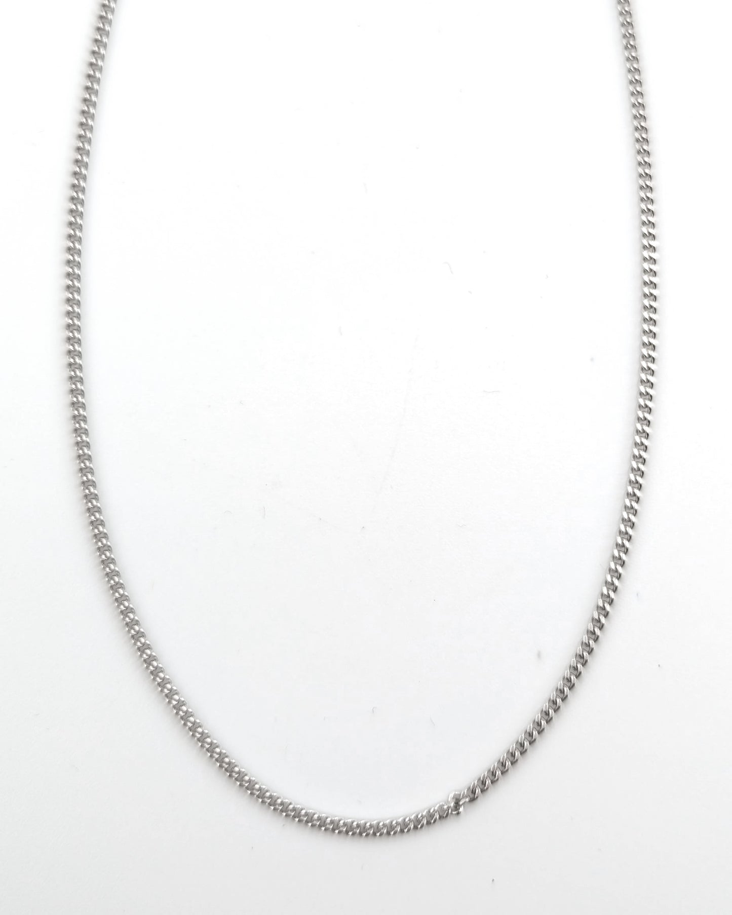 Silver chain necklace on a white background