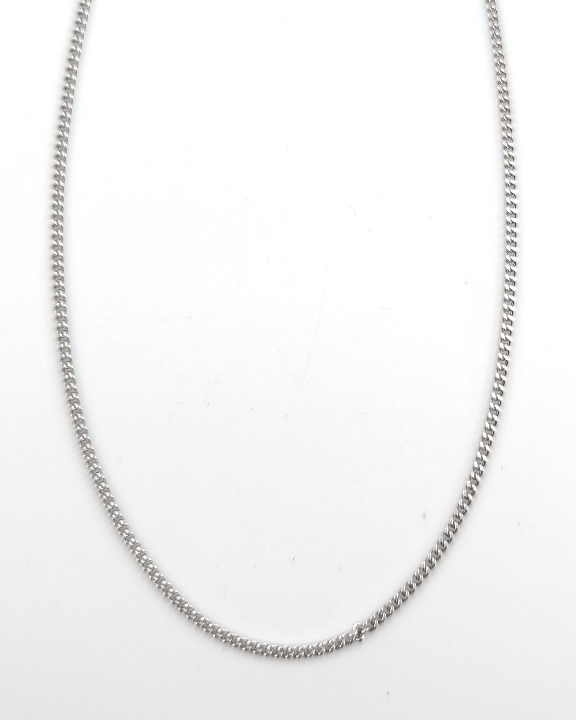 Silver chain necklace on a white background