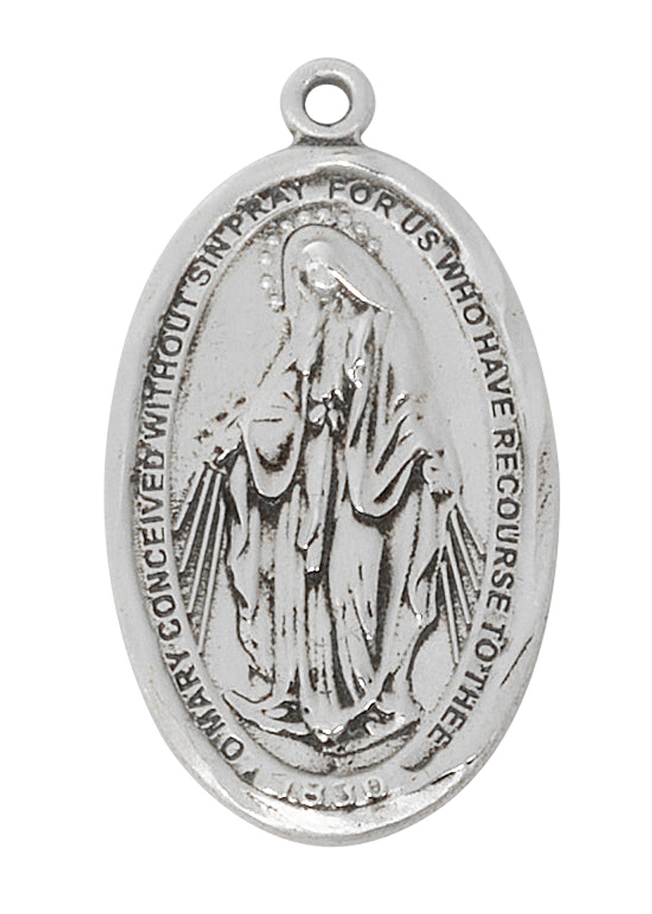 Silver medal with religious design on a white background