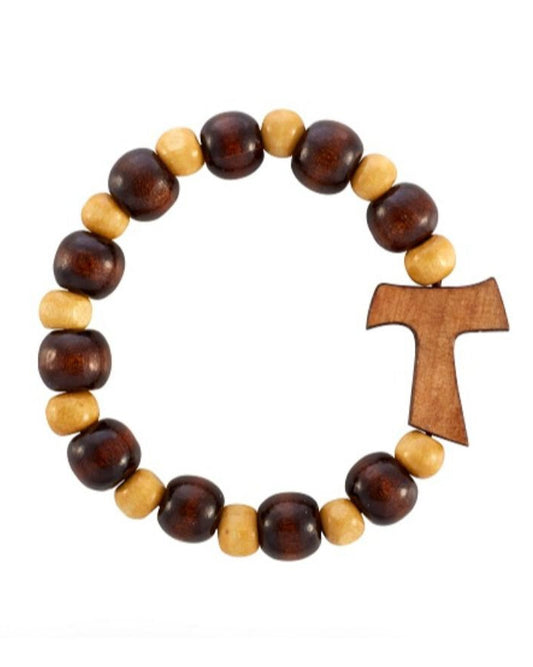 Wooden bracelet with beads and a cross charm on a white background
