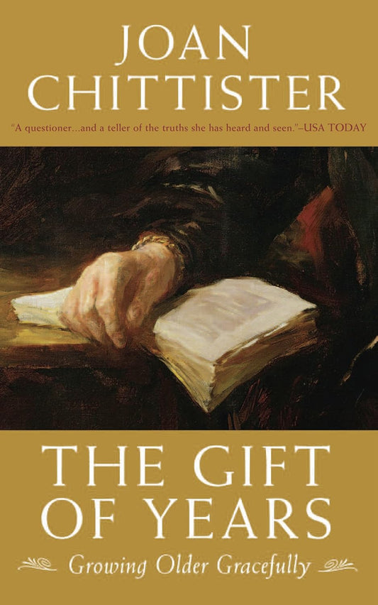 Book cover of 'The Gift of Years' by Joan Chittister with a hand holding an open book.