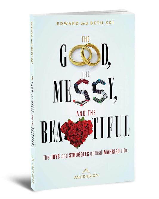 Book titled 'The Good, The Messy, and The Beautiful' with wedding rings and heart design on a light blue background.