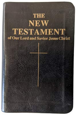A black leather-bound Bible, The New Testament of Our Lord and Savior Jesus Christ, featuring gold lettering and a gold cross on the front cover.