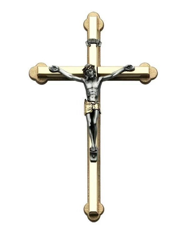Gold and silver crucifix on a white background