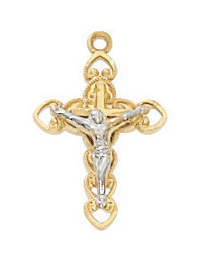 Gold and silver crucifix pendant on a white background