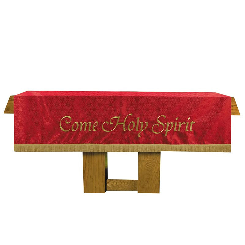 Red cloth with 'Come Holy Spirit' text on a wooden stand against a white background