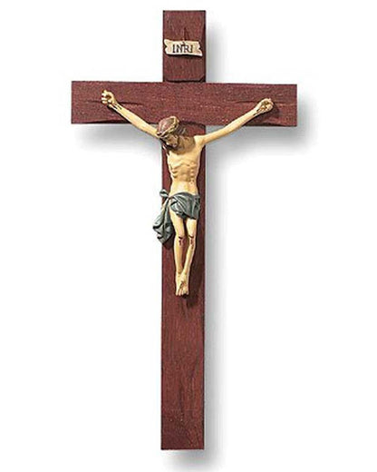 Wooden crucifix with a gold-colored Jesus figure on a white background