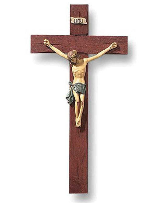 Wooden crucifix with a gold-colored Jesus figure on a white background