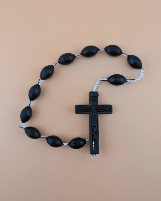 Black rdecade osary with a cross on a beige background
