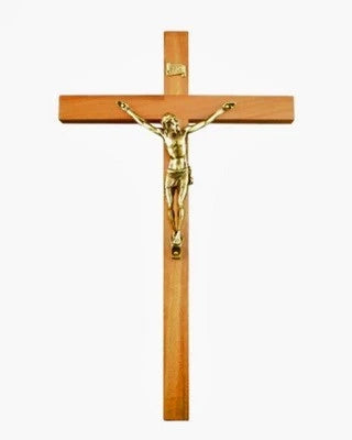 Wooden crucifix with gold Jesus figure on a white background
