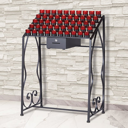 A traditional wrought iron 50-cup Devotional votive candle stand, with red candles placed on it, set against a brick wall backdrop.