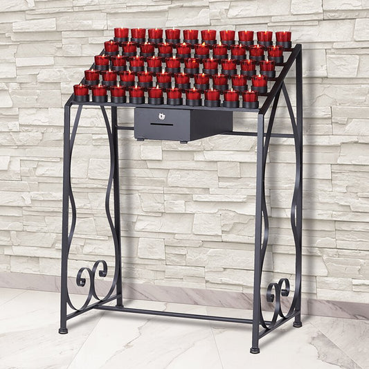 A traditional wrought iron 50-cup Devotional votive candle stand, with red candles placed on it, set against a brick wall backdrop.