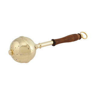Brass ball with a wooden handle on a white background