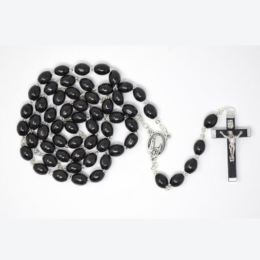 Black rosary with a cross on a white background