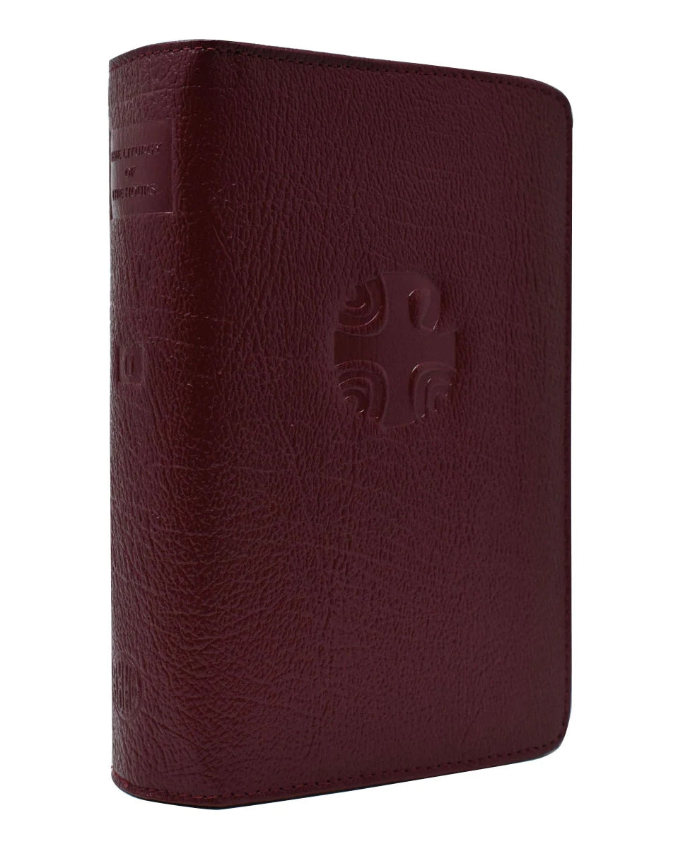 Maroon leather-bound book with a embossed design on a white background