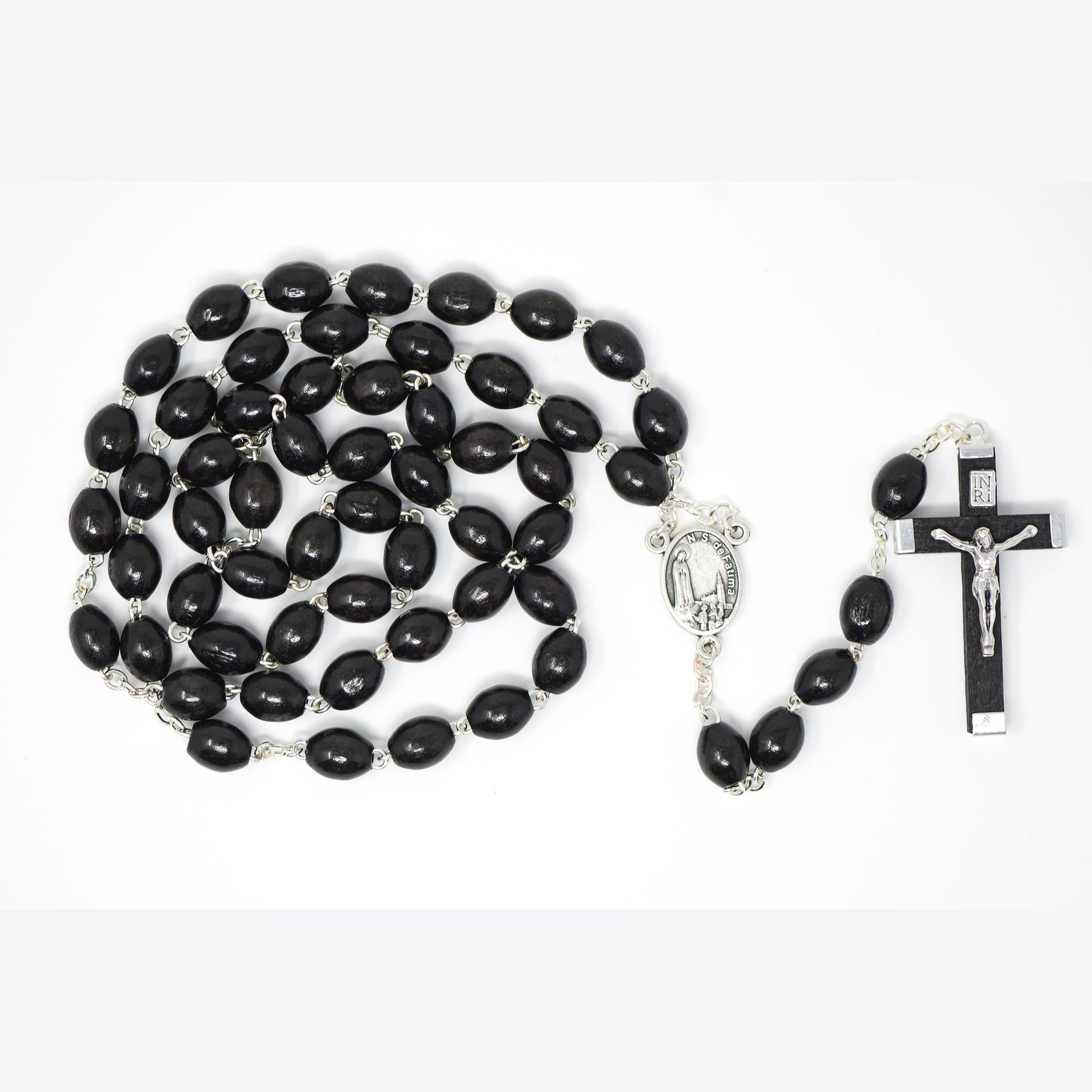 Black rosary beads with silver metal elements on a white background