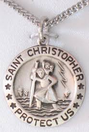 A silver Saint Christopher medal pendant necklace on a matching chain, featuring an embossed depiction of Saint Christopher carrying the cross, with the text 'SAINT CHRISTOPHER PROTECT US' and 'PROTECT THE CHURCH' engraved on a white background.