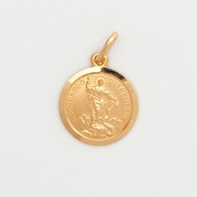 A small round 10K yellow gold medal featuring an image of St. Bernard of Menton.