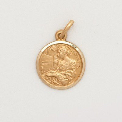 A small round 10K yellow gold medal featuring an engraved image of a saint, with a loop for a chain on the top left.