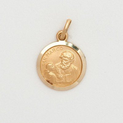 A gold round medal with an image of Saint Mark, attached to a golden loop, displayed against a white background