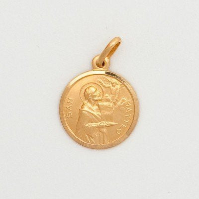 A small round 10K yellow gold medal featuring an embossed image of a saint, with a loop for a chain attachment, displayed against a white background.
